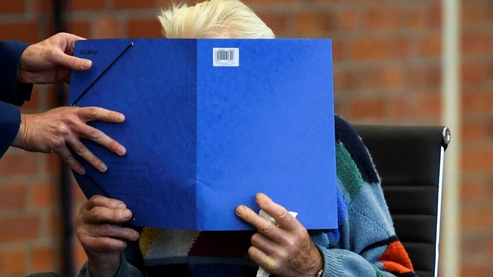 A 100-year-old former security guard of the Sachsenhausen concentration camp appears in the courtroom before his trial at the Landgericht Neuruppin court in Brandenburg, Germany, 7 October 2021