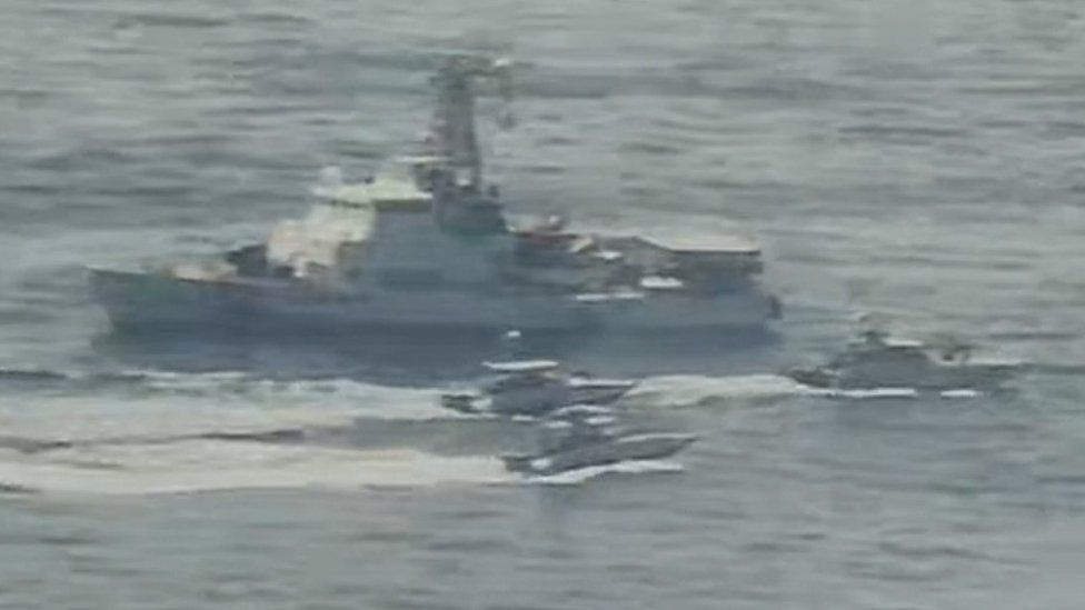 Handout photo from US Navy showing Iranian Islamic Revolutionary Guard Corps Navy (IRGCN) vessels near US vessel in the Gulf (15 April 2020)