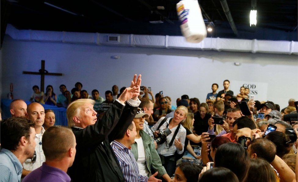 Trump tosses rolls of paper towels into the crowd