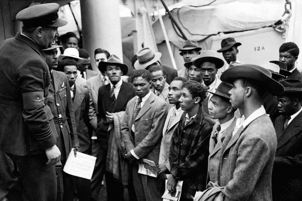 Jamaican immigrants welcomed by RAF officials from the Colonial Office after the ex-troopship HMT 'Empire Windrush' landed them at Tilbury