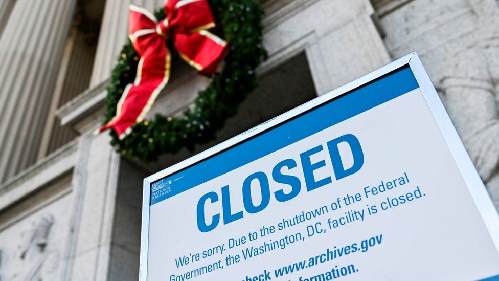 A sign is displayed at the National Archives building that is closed because of a US government shutdown in Washington, DC, on December 22, 2018