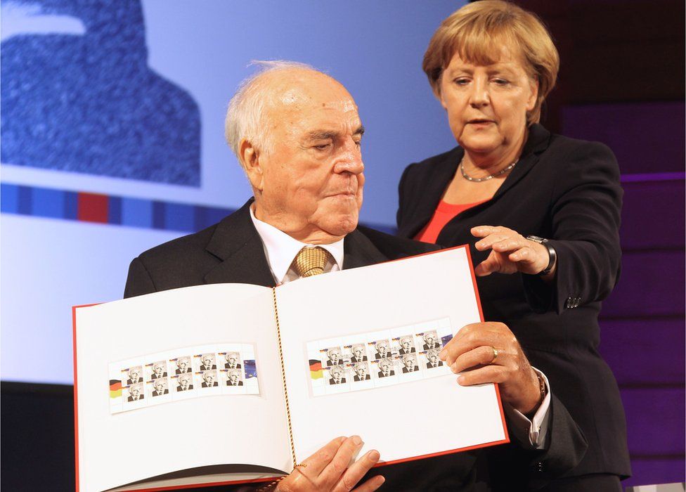 This file photo taken on September 27, 2012 shows Former German Chancellor Helmut Kohl (L) and German Chancellor Angela Merkel (R)