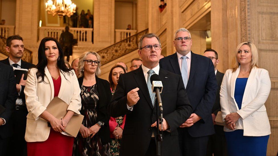 DUP leader Sir Jeffrey Donaldson (C) speaks to the media at Stormont on February 3, 2024 in Belfast, Northern Ireland. Sinn Fein's Michelle O'Neill becomes the new Northern Ireland First Minister
