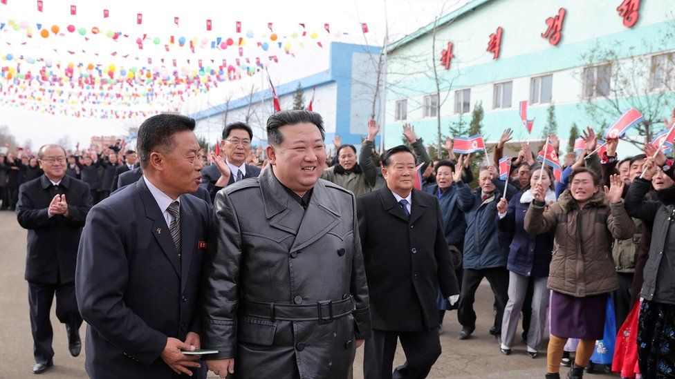 Kim Jong Un, cheered on by locals and surrounded by guards, visits a polling booth in the South Hamgyong Province for the election of delegates to the provincial, city, and county People's Assembly in a photo published by state media on 27 November