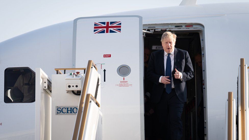 Boris Johnson seen exiting a plane after landing in the UAE