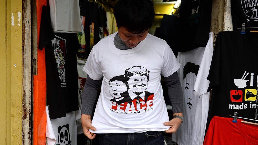 Hanoi vendor wearing T-shirt with Trump and Kim and the word peace on it