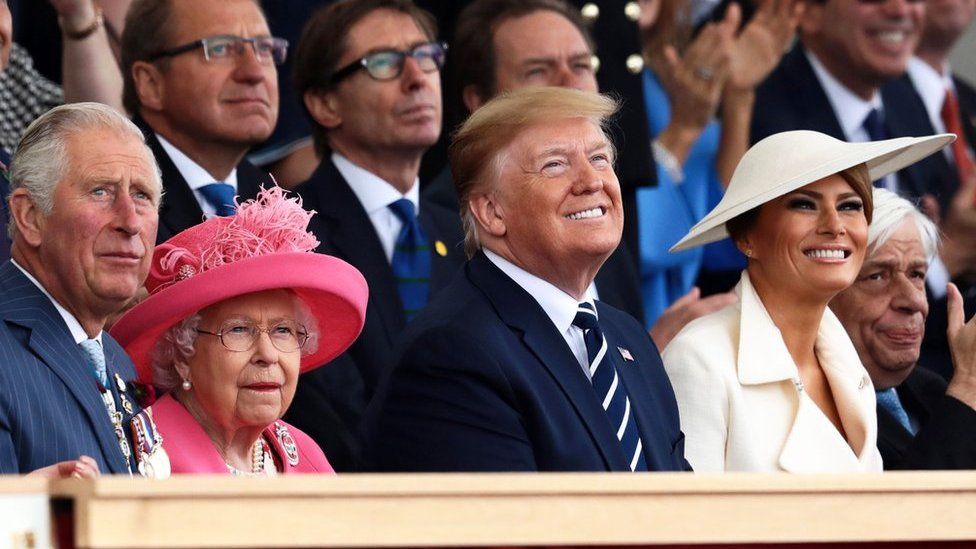 Prince Charles, the Queen and Mr and Mrs Trump look upward