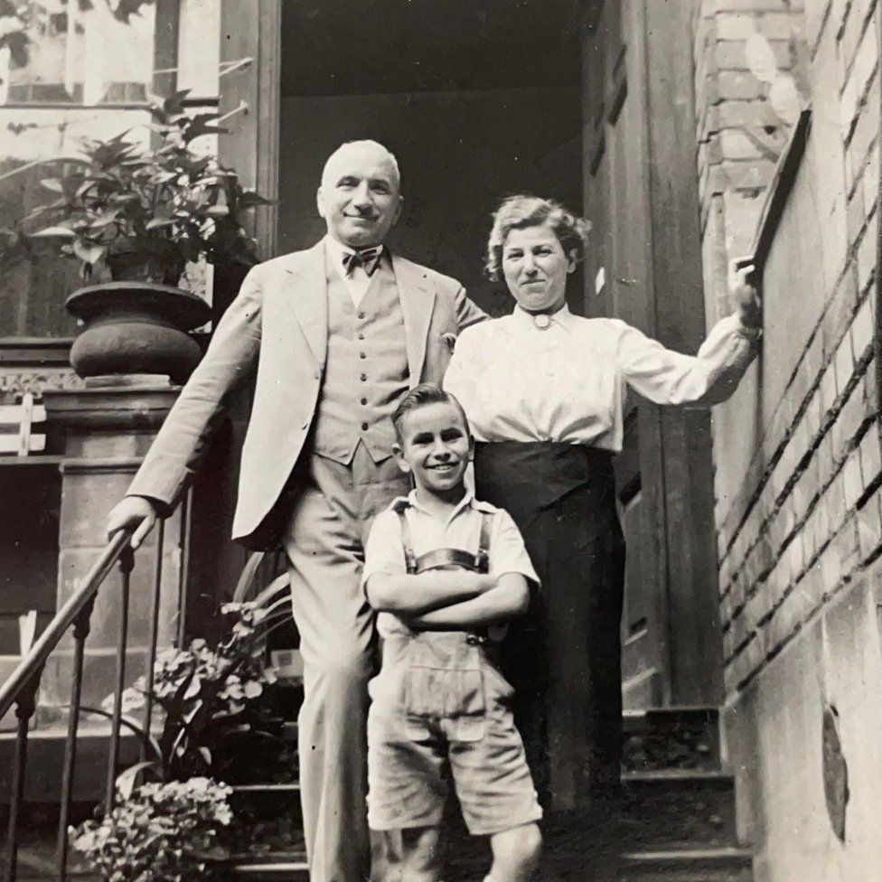 Henry Wuga as a child with his parents