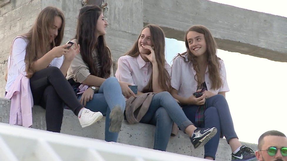 Girls watching a Kosovo training session