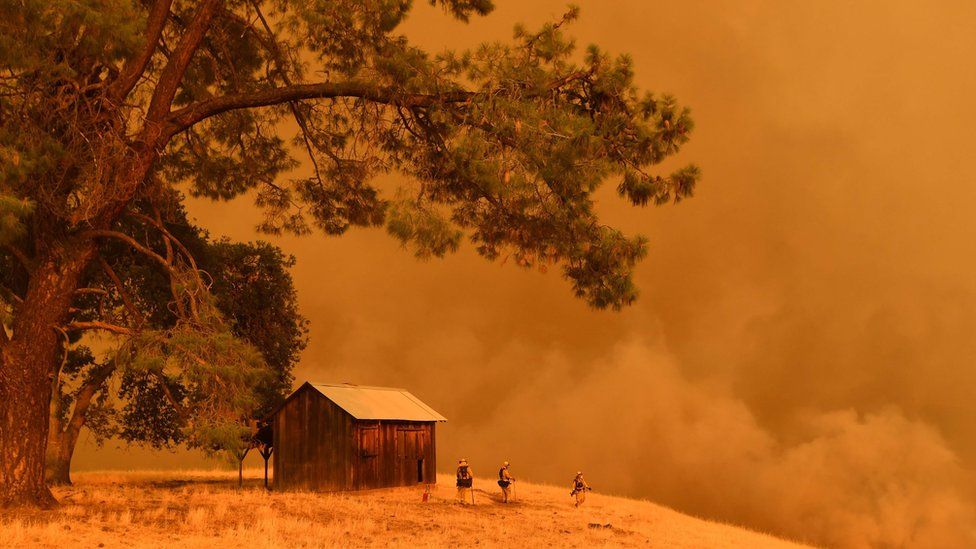 firefighters watch as flames from the County Fire climb a hillside in Guinda, California - 1 July 2018