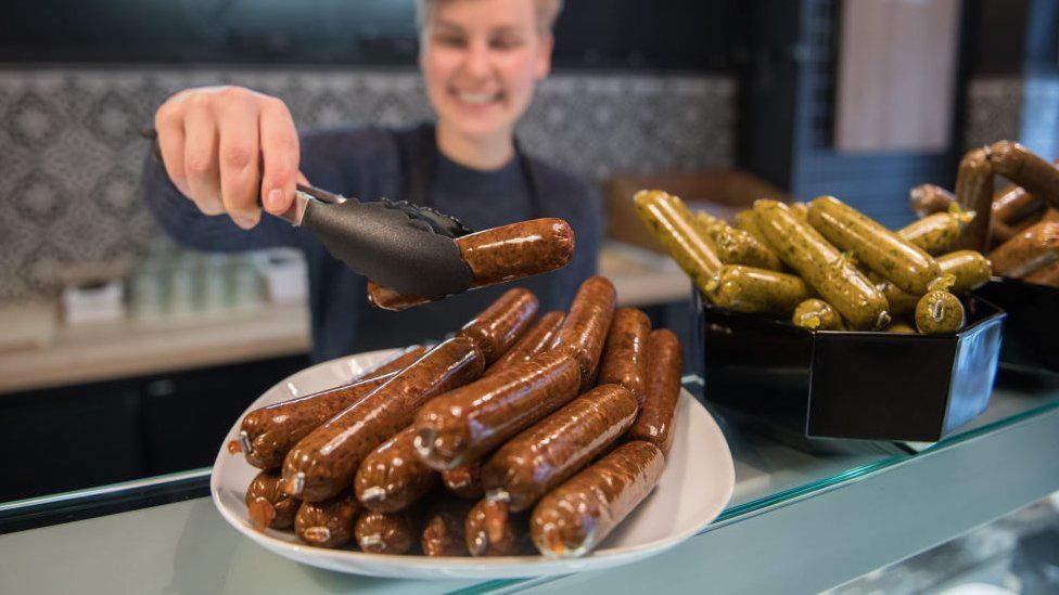 Sarah Pollinger poses in her vegan butchery Vetzgerei, where vegan sausage products are displayed
