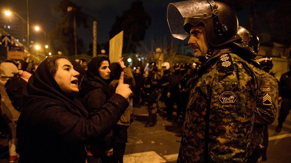 A woman talks to a policeman during a vigil in Tehran for those killed on the Ukraine International Airlines plane shot down by Iran's armed forces (11 January 2020)