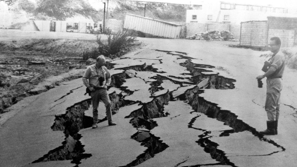 A paved road fissured near the bay shore in western Chimbote