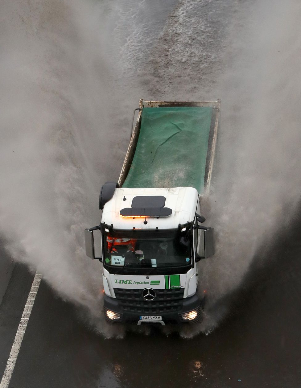 A lorry passes through a flooded road in Folkestone, Kent, on 14 January 2021