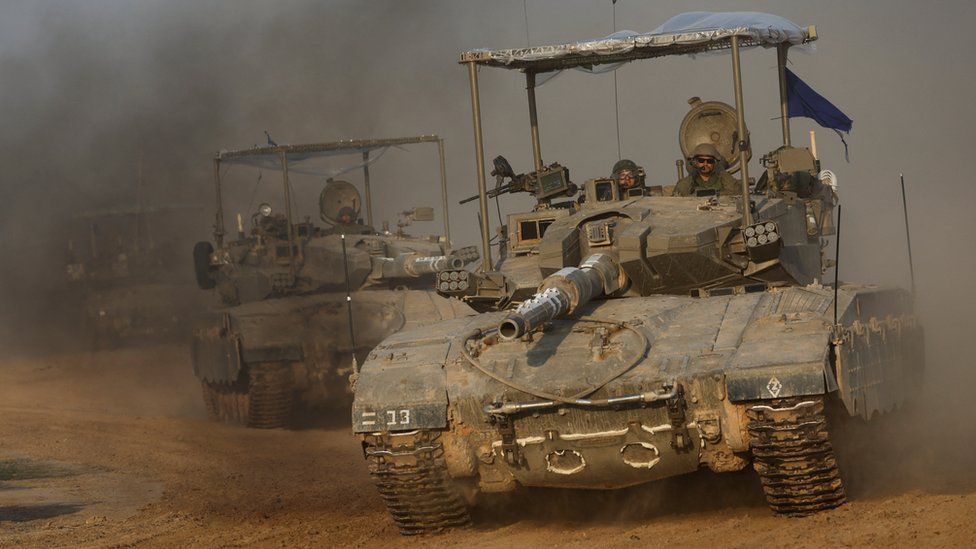 Israeli tanks manoeuvre near Israel's boundary fence with Gaza (4 December 2023)