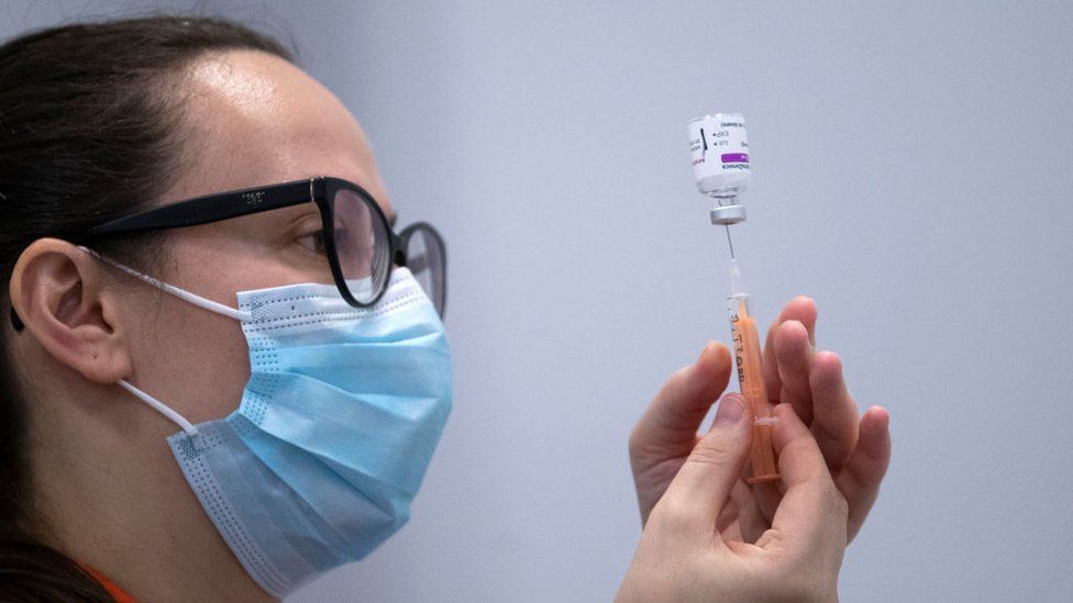 Nurse preparing a shot of the Oxford-AstraZeneca vaccine