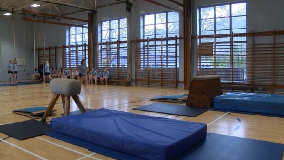 Pupils doing gymnastics in sports hall