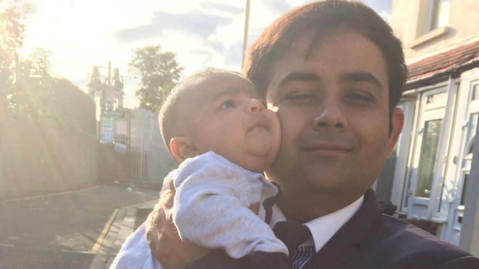 Waseem Iqbal holding his son Muhammad