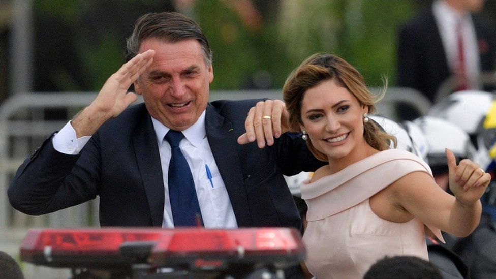Jair Bolsonaro with his wife Michelle in a presidential convoy