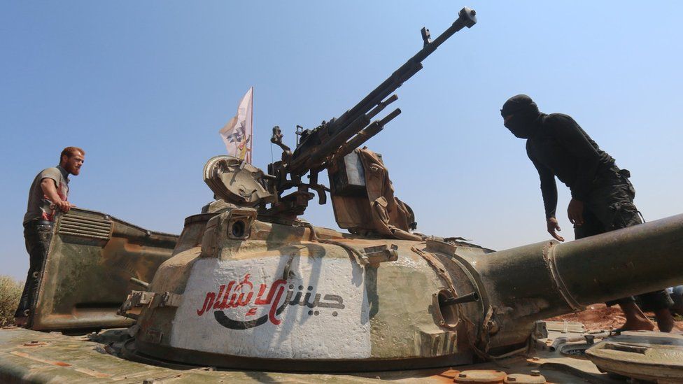 Rebels from Jaysh al-Islam stand on a tank near the frontline on the outskirts of Aleppo (August 2015)
