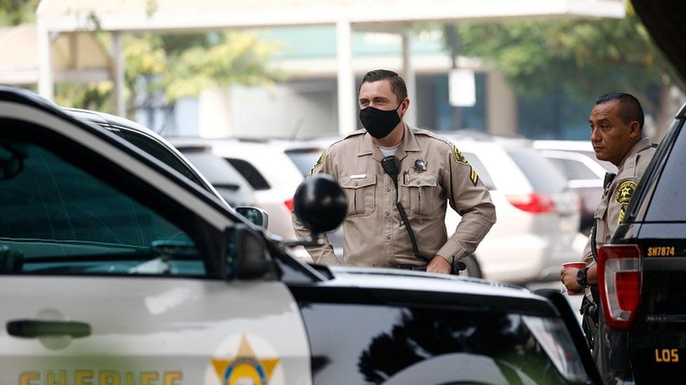 Los Angeles County Sheriffs Department (LASD) deputies stand outside St Francis Medical Center hospital following the ambush shooting