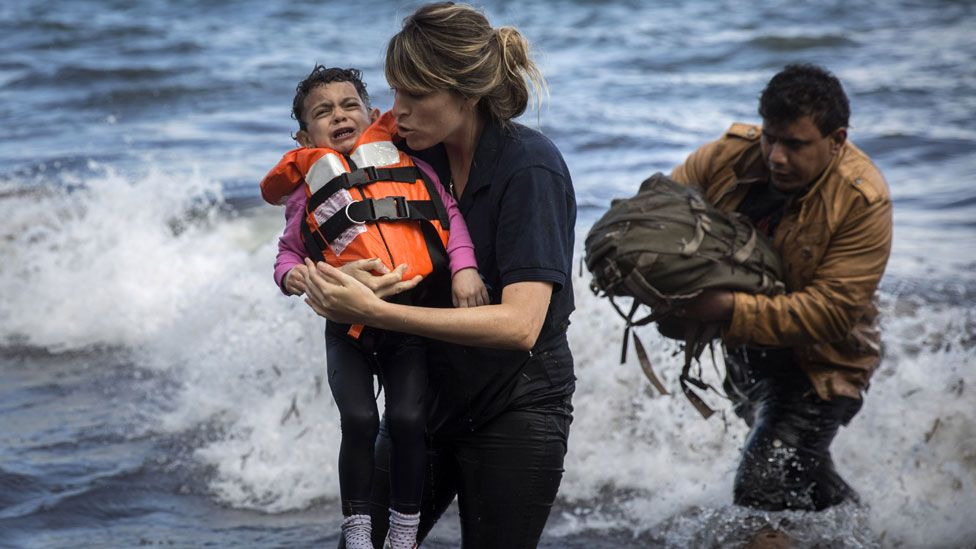 A Syrian child is rescued from a dinghy in Greece