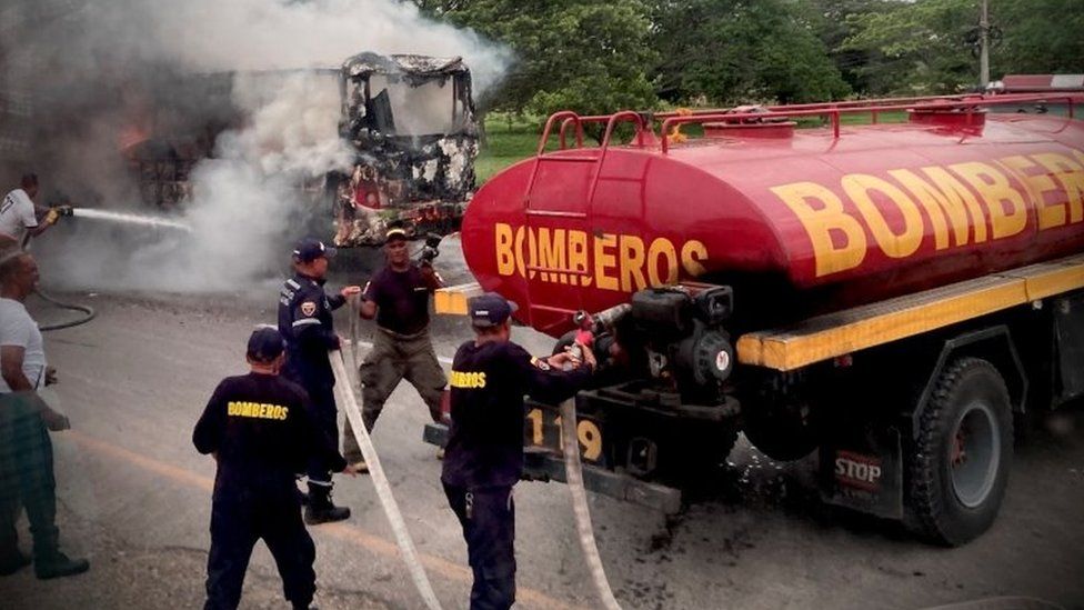 Colombian firefighters tend to a burning vehicle in Bolivar, Colombia May 5, 2022 in this picture obtained from social media. Picture taken May 5, 2022.