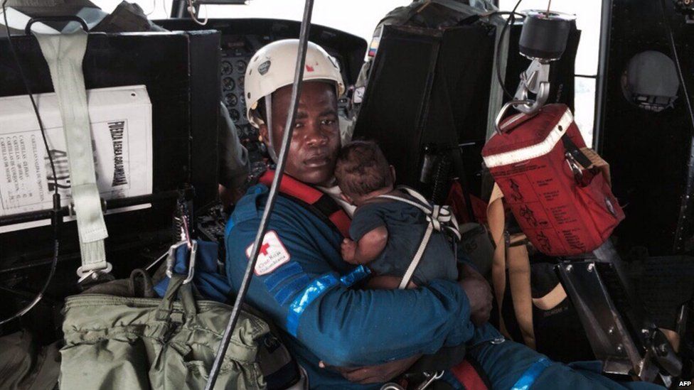 Baby Yudier Moreno held by rescuer on way to Quibdo. 24 June 2015