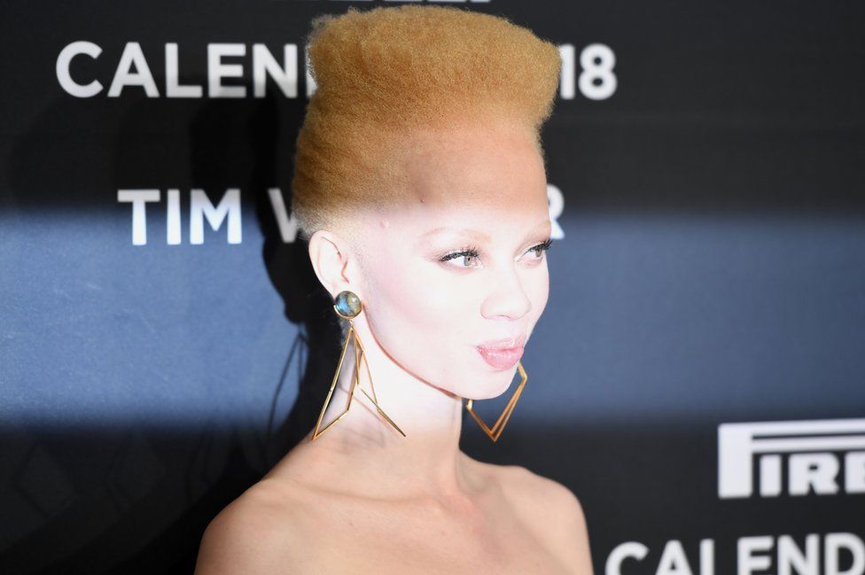 Thando Hopa is lit up on the catwalk.