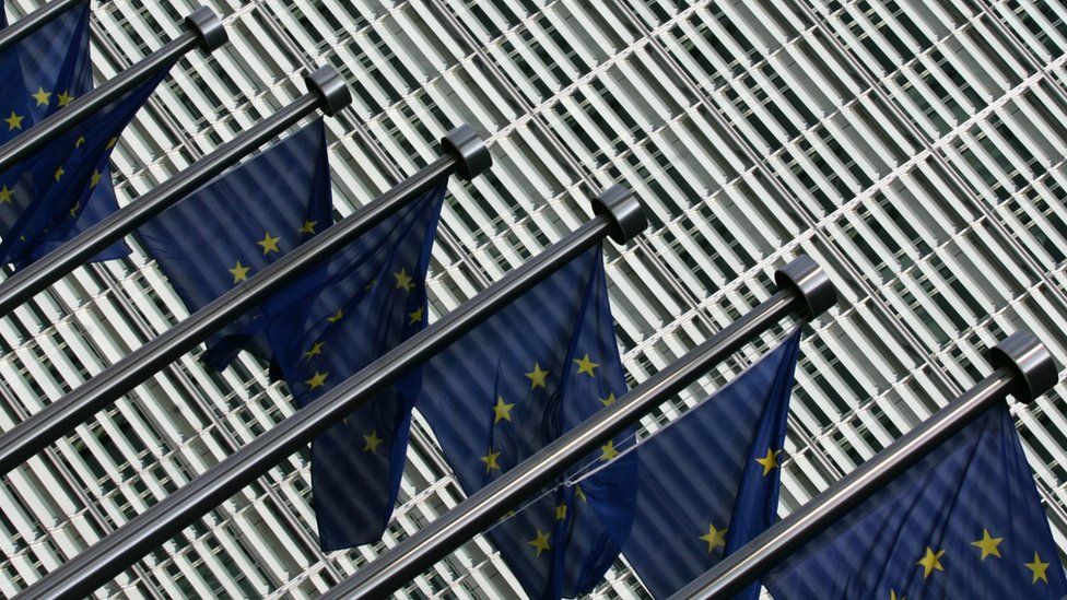 Flags of the European Union flutter at the entrance of the European Commission's Berlaymont building at the EU headquarters in Brussels
