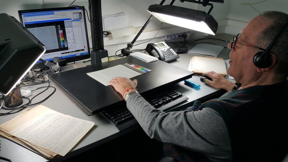 Person digitising archives at Yad Vashem