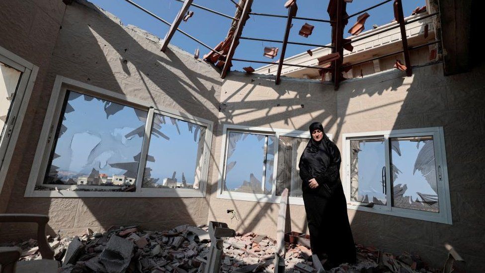 Chadia Kaddouh, stands amid rubble of her house that was destroyed by what she said was Israeli shelling, amidst tension between Israel and Hezbollah, in the southern town of Yater, Lebanon November 1, 2023.