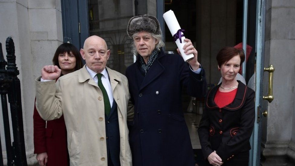 Bob Geldof (centre) hands back his Freedom of Dublin award