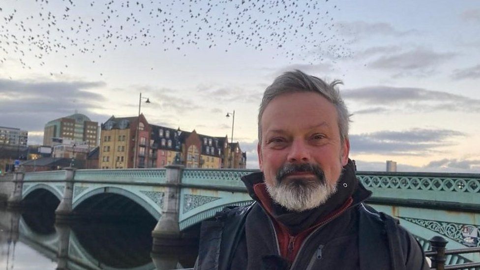 Colin Shaw pictured with the murmuration of starlings