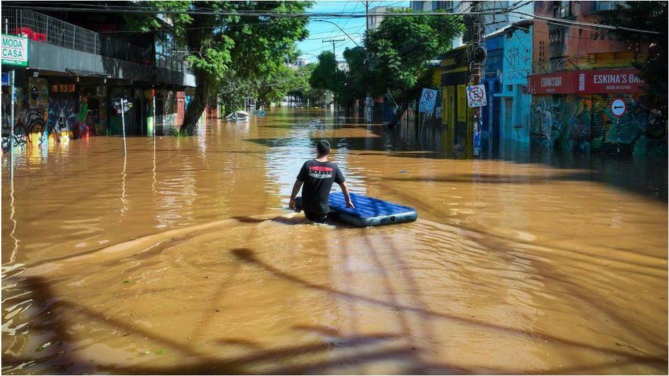 Man in flooded street in Porto Alegre