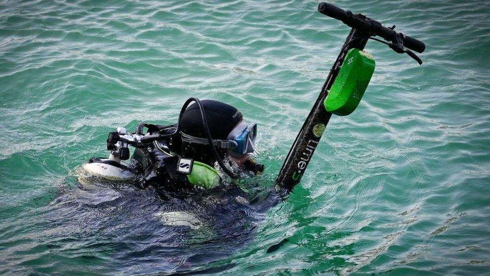 An e-scooter belonging to US firm Lime is fished out of the sea in Marseille