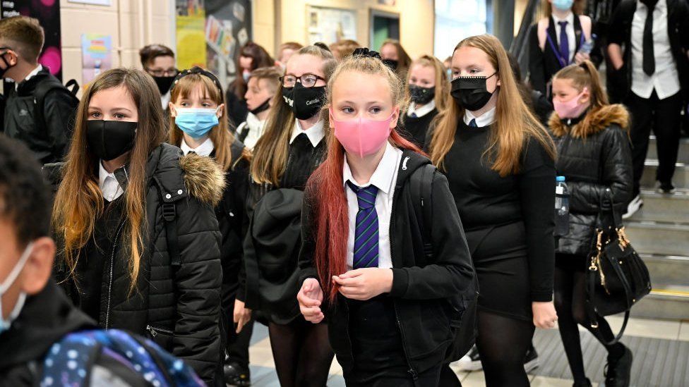 School corridor with secondary school pupils wearing masks