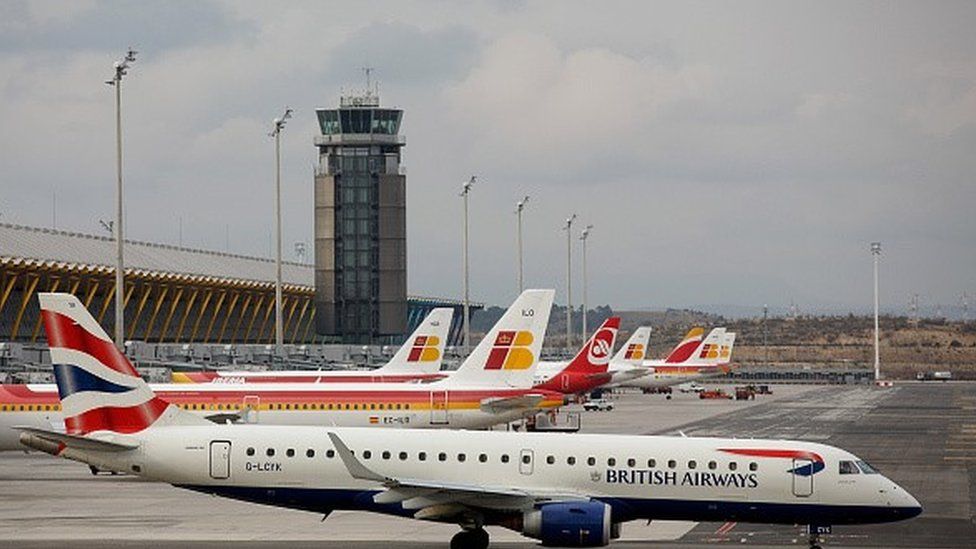 A British Airways plane in front of Iberia's planes in Madrid