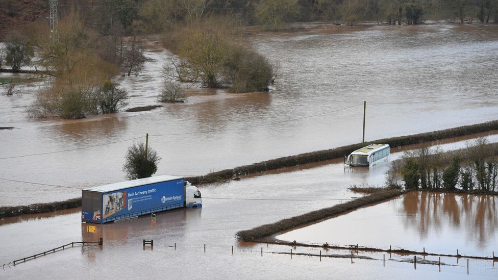 A lorry and a coach submerged in floodwater from the River Teme on the A443 near Lindridge, Worcestershire