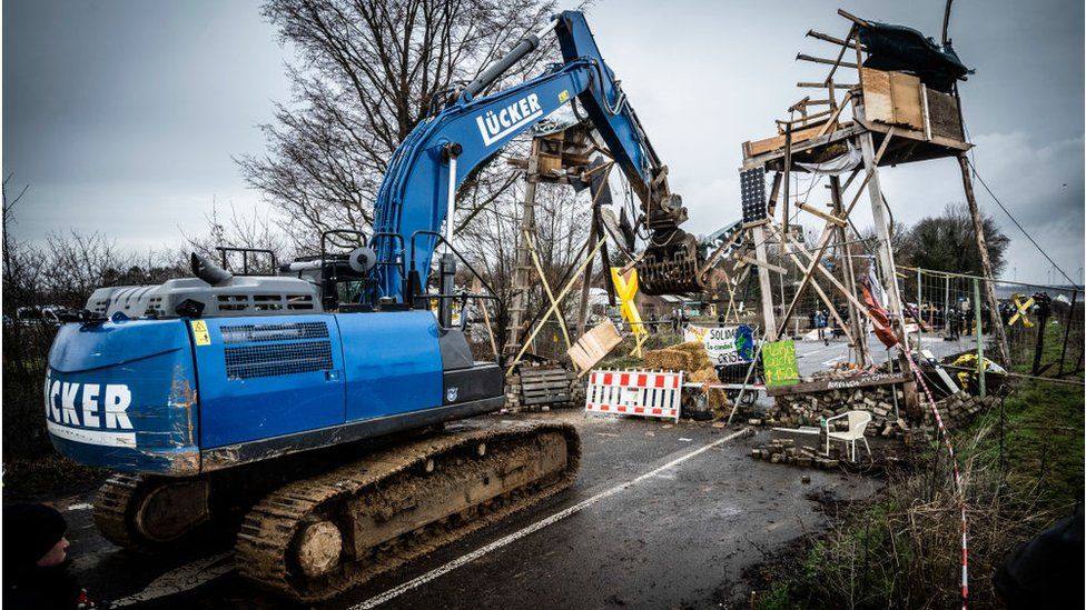A digger destroys a wooden structure on January 2, 2023 in Luetzerath, Germany.