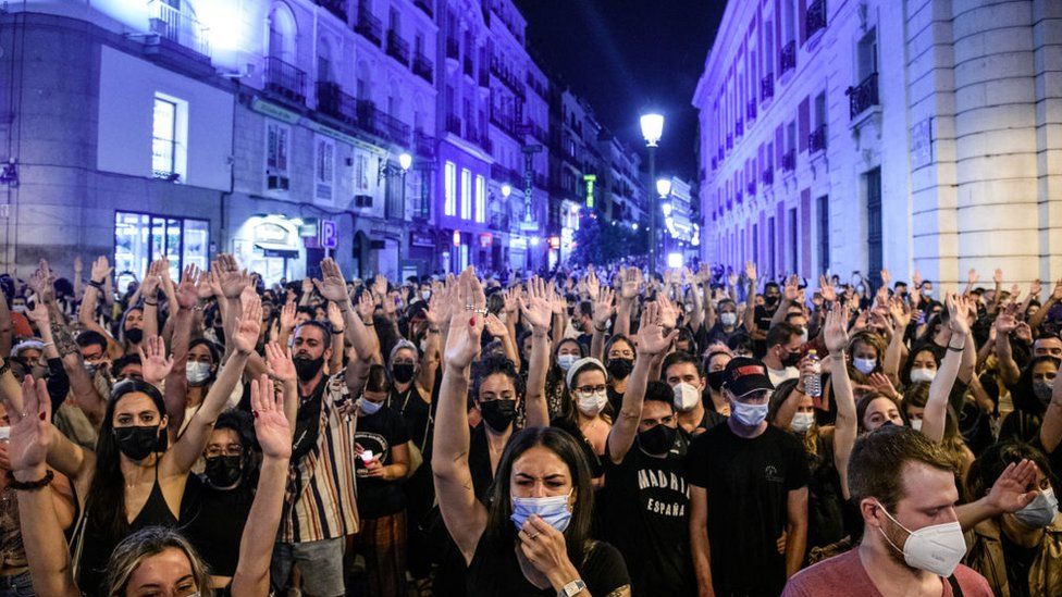 Protesters with their hands in the air