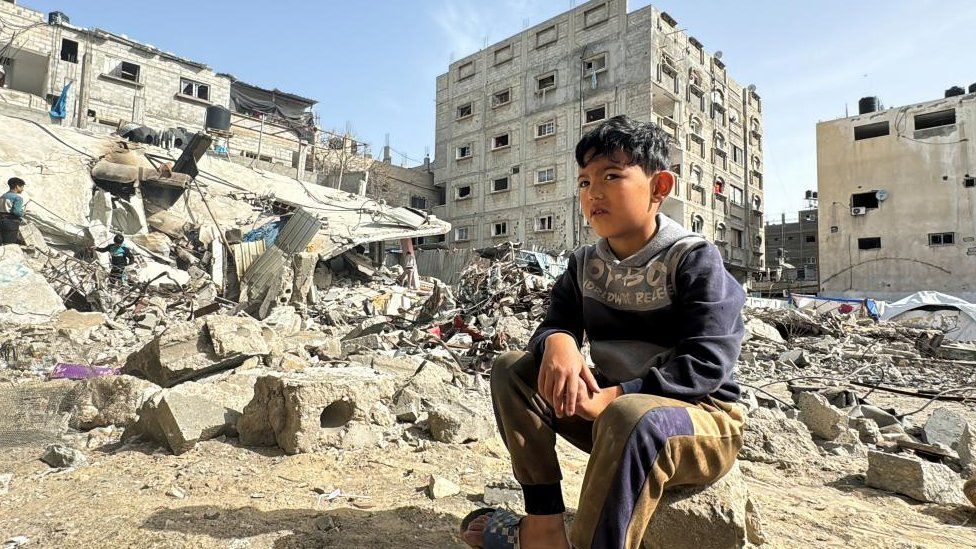 A Palestinian boy sits on the site of an Israeli strike, amid the ongoing conflict between Israel and the Palestinian Islamist group Hamas, in Rafah, in the southern Gaza Strip, March 27, 2024.