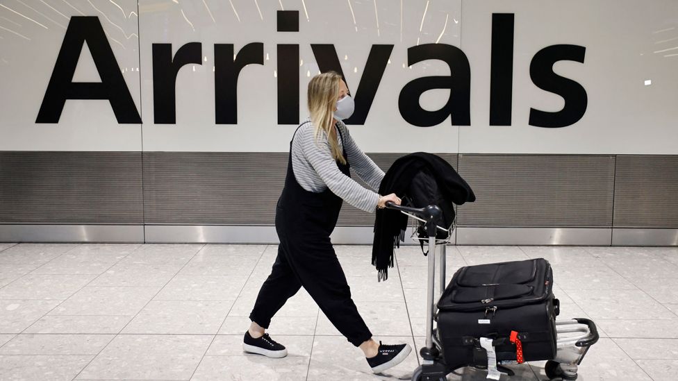 People arrive at Heathrow's Terminal 5 in west London on August 2, 2021 as quarantine restrictions ease