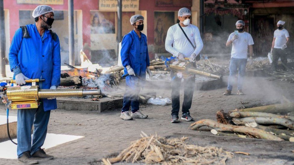 Volunteers spray disinfectant at the Shivpuri Hindu cremation ground during a government-imposed nationwide lockdown as a preventive measure against the COVID-19 coronavirus, in Amritsar on April 11, 2020.
