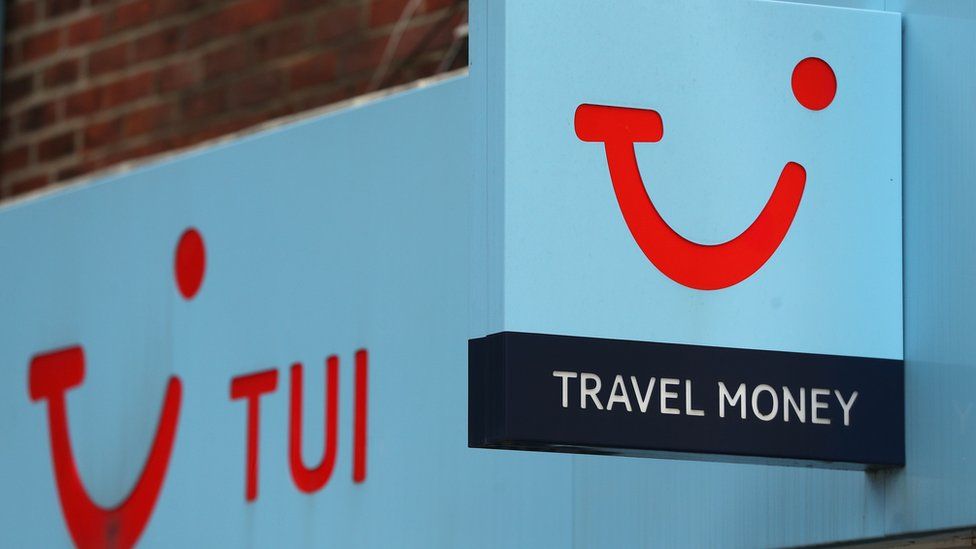 A red and blue logo outside a Tui shop