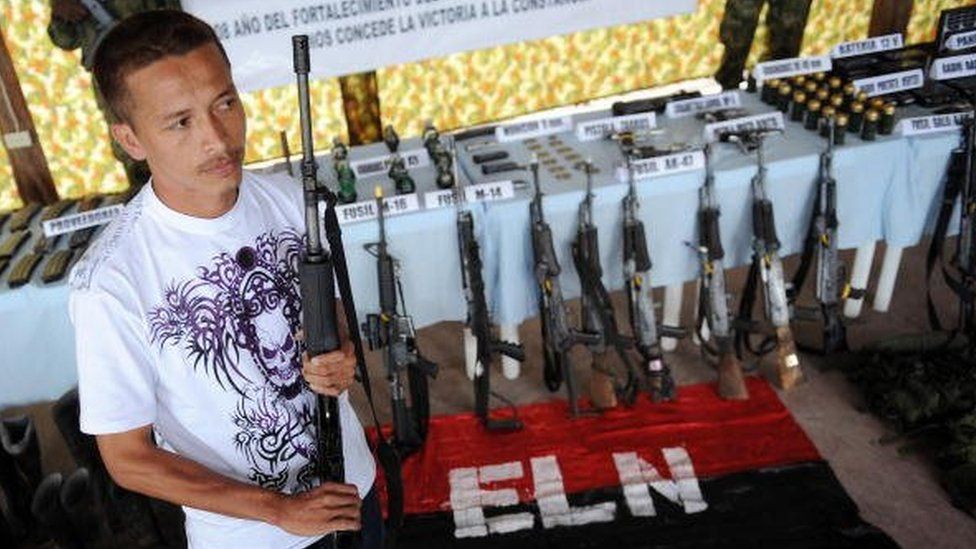 A member of the National Liberation Army (ELN) holds his AK-47 before surrendering it to the Colombian Army on December 7, 2008, in Quibdo, department of Choco, Colombia.