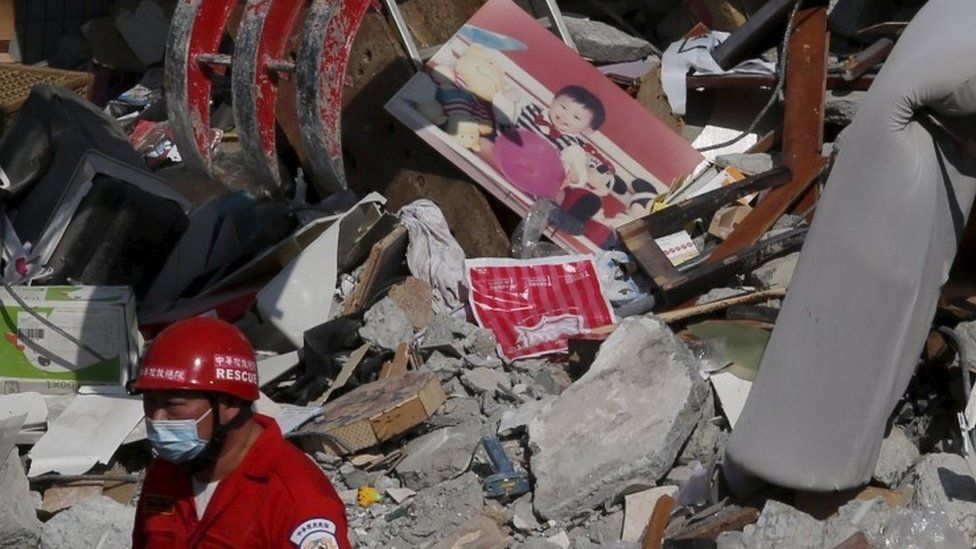 A photo of a child is seen among the ruins of a 17-storey apartment building that collapsed after an earthquake hit Tainan, southern Taiwan February 7, 2016