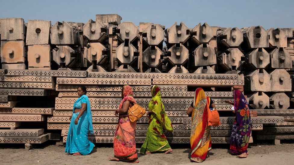 Devotees walk past pillars in the city of Ajodhya, India
