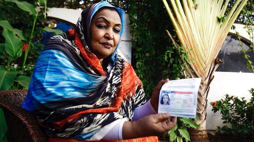 Sudanese citizen Fatima Abul Qasim Gash shows her US visa in her passport during an interview with AFP in Khartoum on January 29, 2017 after she was turned back at Doha airport after US President Donald Trump signed a sweeping executive order to suspend refugee arrivals and impose tough controls on travellers from Iran, Iraq, Libya, Somalia, Sudan, Syria and Yemen, speaks during an interview with AFP in Khartoum on January 29, 2017
