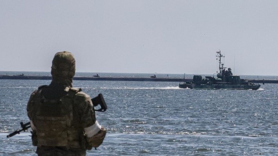 A Russian navy boat patrols the harbour in Mariupol